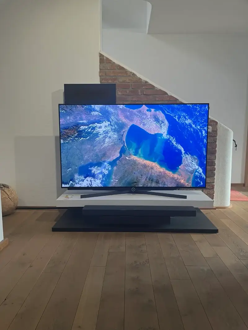 Fernseher mit Tischfuß auf einem Lowboard im Showroom